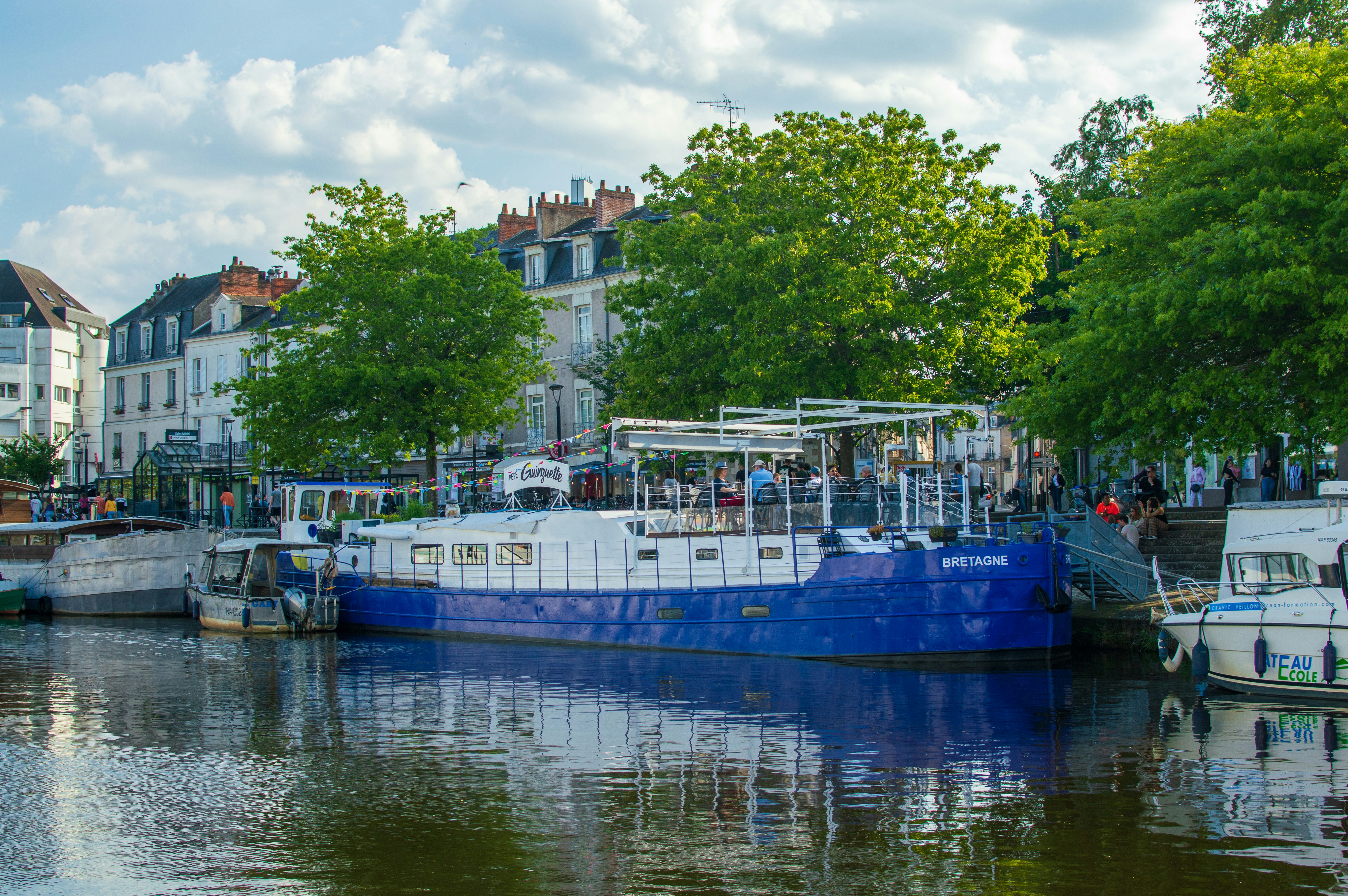 a blue and white boat in a body of water